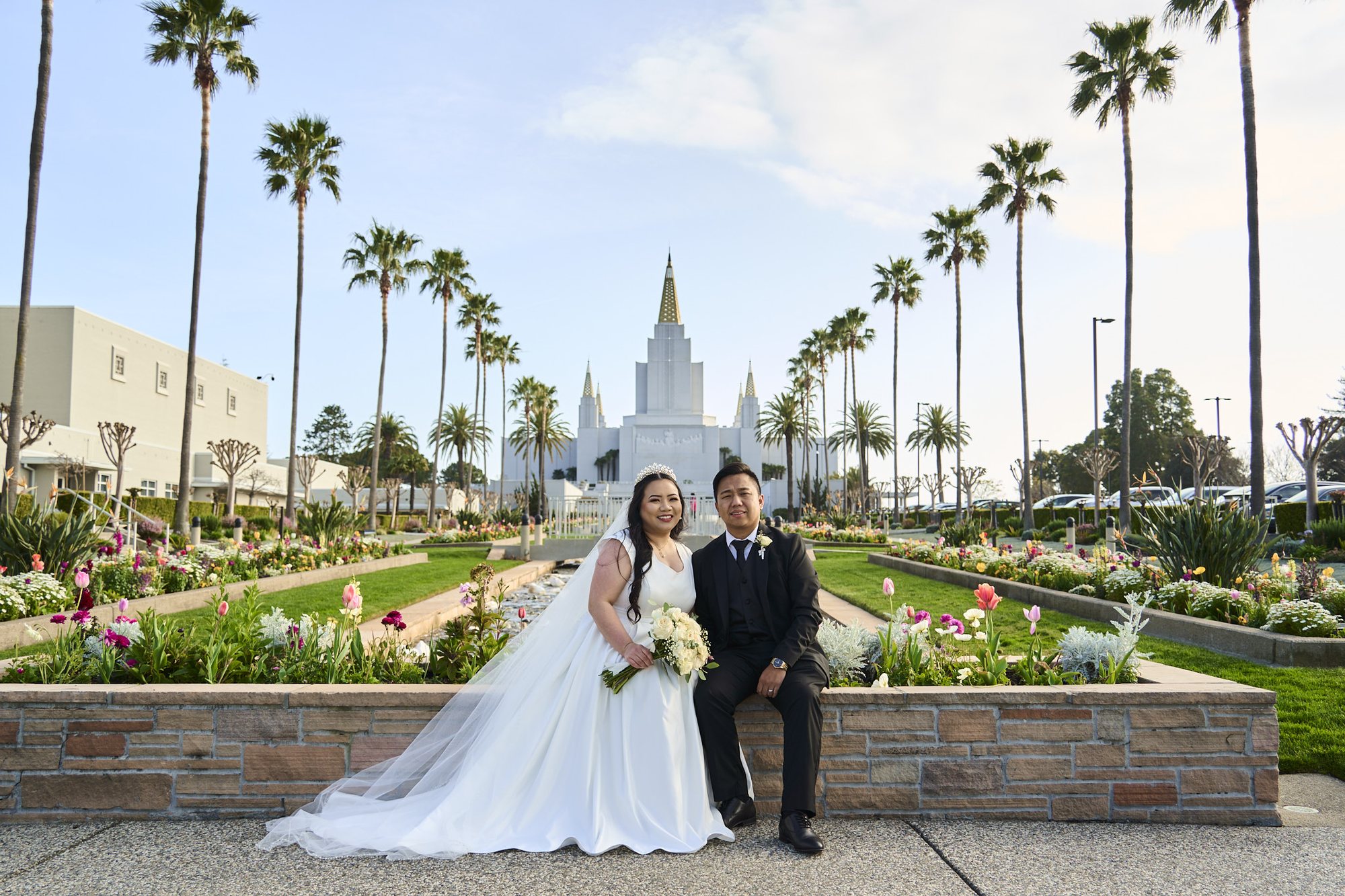 Chia and Thong together in the garden with the temple behind them