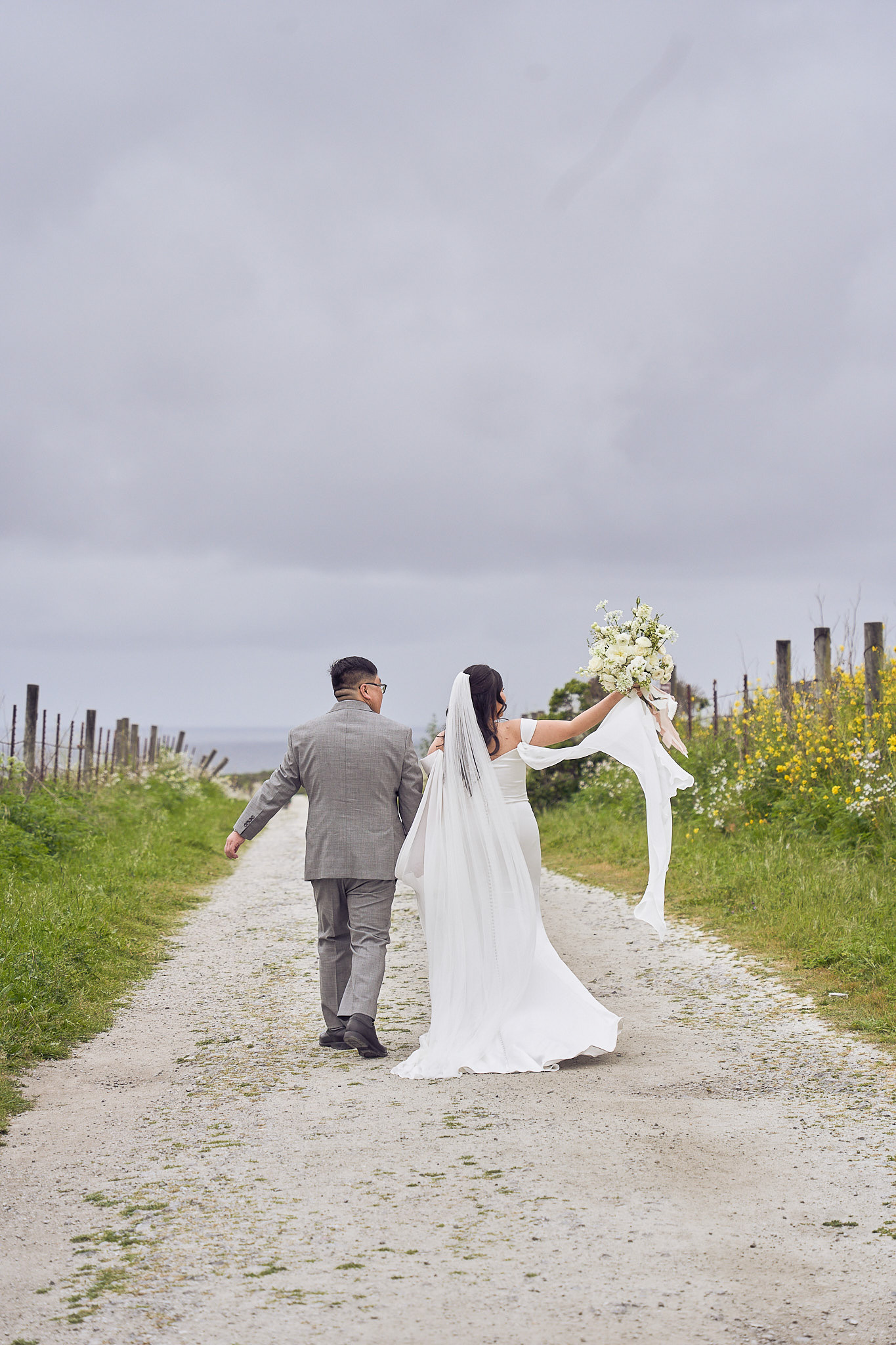 Newlyweds walking along a country path